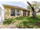 Exterior backyard view showcasing lush green grass, a well-maintained fence, and a charming exterior at 12506 Safari Ln, Riverview, FL 33579