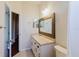 Bathroom featuring a single sink vanity, framed mirror and modern lighting at 12506 Safari Ln, Riverview, FL 33579
