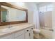 Bathroom featuring a single sink vanity, framed mirror, and shower with tub at 12506 Safari Ln, Riverview, FL 33579
