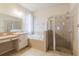 Bright bathroom featuring a soaking tub with tile surround and shower with glass door at 12506 Safari Ln, Riverview, FL 33579