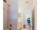 Tiled bathroom with shower, sink, and view into another room with a computer desk at 12506 Safari Ln, Riverview, FL 33579