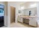 Bathroom with double vanity sinks and access to other rooms at 12506 Safari Ln, Riverview, FL 33579