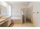 Bathroom with tub, vanity and framed glass shower at 12506 Safari Ln, Riverview, FL 33579