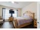 Bedroom with wood floor, ornate bed frame and dresser, plus large window at 12506 Safari Ln, Riverview, FL 33579