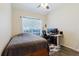 Bedroom with a twin bed, desk, modern black desk chair and fish print rug at 12506 Safari Ln, Riverview, FL 33579