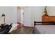 View from bedroom into ensuite bathroom with white cabinets and framed mirror at 12506 Safari Ln, Riverview, FL 33579