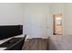 Bedroom featuring hardwood floors, a bed, a door, and a glimpse into the bathroom at 12506 Safari Ln, Riverview, FL 33579