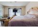 Bedroom with wood floor, ornate bed frame and upholstered chair with ottoman at 12506 Safari Ln, Riverview, FL 33579
