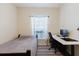 Bedroom with a twin bed, white desk, a modern black desk chair and gray striped rug at 12506 Safari Ln, Riverview, FL 33579