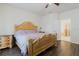Bedroom with wood floor, ornate bed frame and opening to bathroom at 12506 Safari Ln, Riverview, FL 33579