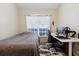 Bedroom with a twin bed, desk, modern black desk chair and fish print rug at 12506 Safari Ln, Riverview, FL 33579
