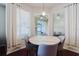 Charming dining area with gray chairs and a round marble-look table, enhanced by the natural light from adjacent windows at 12506 Safari Ln, Riverview, FL 33579