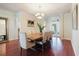 Bright dining room features a modern chandelier and views of the outdoor space through french doors at 12506 Safari Ln, Riverview, FL 33579