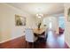 Elegant dining room with wood floors, chandelier lighting, and seating for six at 12506 Safari Ln, Riverview, FL 33579