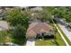 Charming single-story home with a well-manicured lawn, mature trees, and a welcoming entrance at 12506 Safari Ln, Riverview, FL 33579