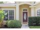Close up of the entrance to a home with an attractive front door and well-kept landscaping at 12506 Safari Ln, Riverview, FL 33579