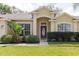 Charming home featuring a beautiful front door with decorative glass and manicured landscaping at 12506 Safari Ln, Riverview, FL 33579