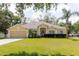 Charming single-story home with a well-manicured lawn, lush landscaping, and a two-car garage at 12506 Safari Ln, Riverview, FL 33579