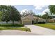 Well-maintained home with a spacious driveway, mature trees, and meticulously kept lawn at 12506 Safari Ln, Riverview, FL 33579