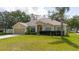 Beautiful single-Gathering home with manicured lawn, mature trees, and inviting curb appeal at 12506 Safari Ln, Riverview, FL 33579