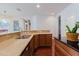 Open kitchen featuring stainless steel dishwasher and sink, wood cabinets and tile backsplash at 12506 Safari Ln, Riverview, FL 33579