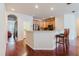 Open-concept kitchen with bar seating, stainless steel appliances, and wood cabinetry at 12506 Safari Ln, Riverview, FL 33579