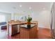 Open kitchen with stainless steel appliances and central island transitions to a dining area, creating a connected living space at 12506 Safari Ln, Riverview, FL 33579