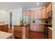 Well-equipped kitchen featuring stainless steel appliances, wooden cabinetry, and a central island at 12506 Safari Ln, Riverview, FL 33579