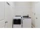 Laundry room featuring a Whirlpool washer and dryer, wire shelving, and a white door at 12506 Safari Ln, Riverview, FL 33579