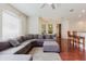 Open living room with a large sectional sofa, fan, and view into kitchen at 12506 Safari Ln, Riverview, FL 33579