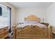 Spacious bedroom showcasing an ornately designed bed frame, complementing nightstands, and soft natural light at 12506 Safari Ln, Riverview, FL 33579