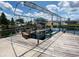 Features a boat dock on the water with a boat lift and seating area to enjoy the waterfront at 13930 King Ave, Hudson, FL 34669