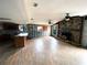 Spacious open-concept living room with fireplace and natural light, ideal for entertaining and relaxation at 13930 King Ave, Hudson, FL 34669