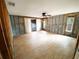 A bright, spacious living room with exposed concrete block walls, new floors, and windows at 13930 King Ave, Hudson, FL 34669
