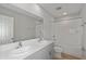 Modern bathroom features double sink vanity, granite counters, and tiled tub and shower at 14773 Summer Branch Dr, Lithia, FL 33547