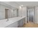 Bathroom featuring double sinks with quartz countertops and ample cabinet space at 14773 Summer Branch Dr, Lithia, FL 33547