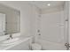 Bright bathroom featuring a shower-tub combo, modern vanity, and white tiling at 14773 Summer Branch Dr, Lithia, FL 33547