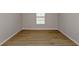 Neutral bedroom with wood floors and bright window at 14773 Summer Branch Dr, Lithia, FL 33547