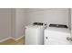 Laundry room equipped with a modern washer and dryer, plus built-in shelving at 14773 Summer Branch Dr, Lithia, FL 33547