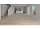 Spacious, modern living room with stairs and seamless flow to the kitchen area at 14773 Summer Branch Dr, Lithia, FL 33547