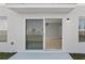 Covered outdoor patio with sliding glass door entry to home's interior at 14773 Summer Branch Dr, Lithia, FL 33547