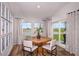 Dining area with a round table, seating for four, and sliding glass doors to the backyard at 14781 Summer Branch Dr, Lithia, FL 33547
