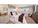 Cozy main bedroom featuring natural light, carpet, and a large comfortable bed at 14781 Summer Branch Dr, Lithia, FL 33547