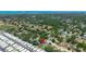 The aerial view captures the home nestled in a neighborhood close to a school, amenities, and waterfront at 1509 Coachlight Way, Dunedin, FL 34698