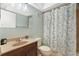 Cozy bathroom featuring neutral tones, floral shower curtain, and vanity sink at 1509 Coachlight Way, Dunedin, FL 34698