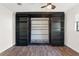 Bedroom features hardwood floors, ceiling fan, and a built-in dark bookcase with a Murphy bed at 1509 Coachlight Way, Dunedin, FL 34698