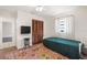 Bright bedroom features wood-look closet doors, stylish area rug, and large window letting in natural light at 1509 Coachlight Way, Dunedin, FL 34698