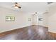 Spacious bedroom with hardwood floors, three windows and built in white wardrobe at 1509 Coachlight Way, Dunedin, FL 34698