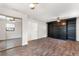 Bedroom features hardwood floors, ceiling fan, and a built-in dark bookcase at 1509 Coachlight Way, Dunedin, FL 34698