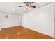Bedroom featuring hardwood floors and a large closet at 1509 Coachlight Way, Dunedin, FL 34698